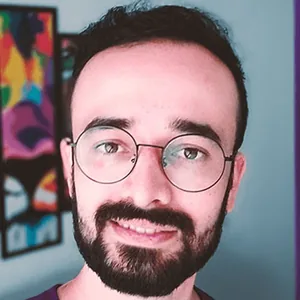 Retrato do Leo Moreira, de óculos e camiseta roxa